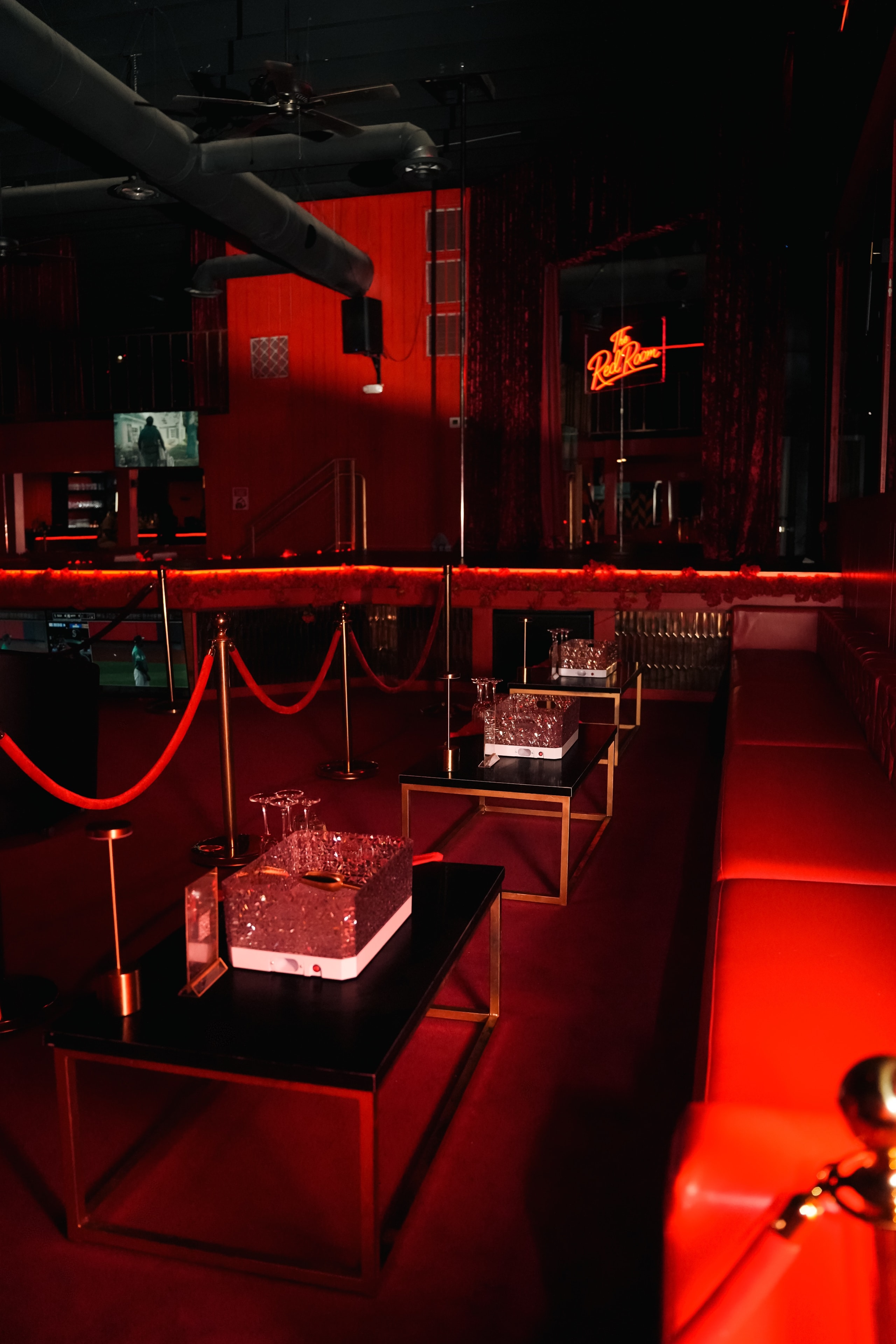 The Red Room VIP interior with neon sign and bottle service tables